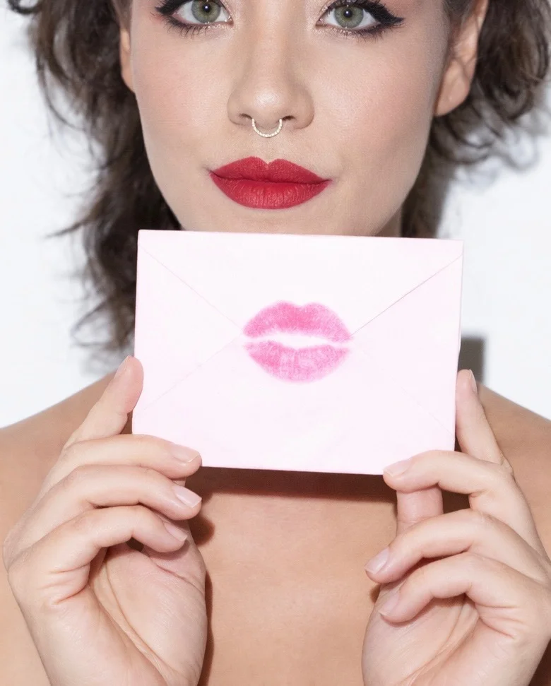 Felicia Kalani holding envelope with kiss print